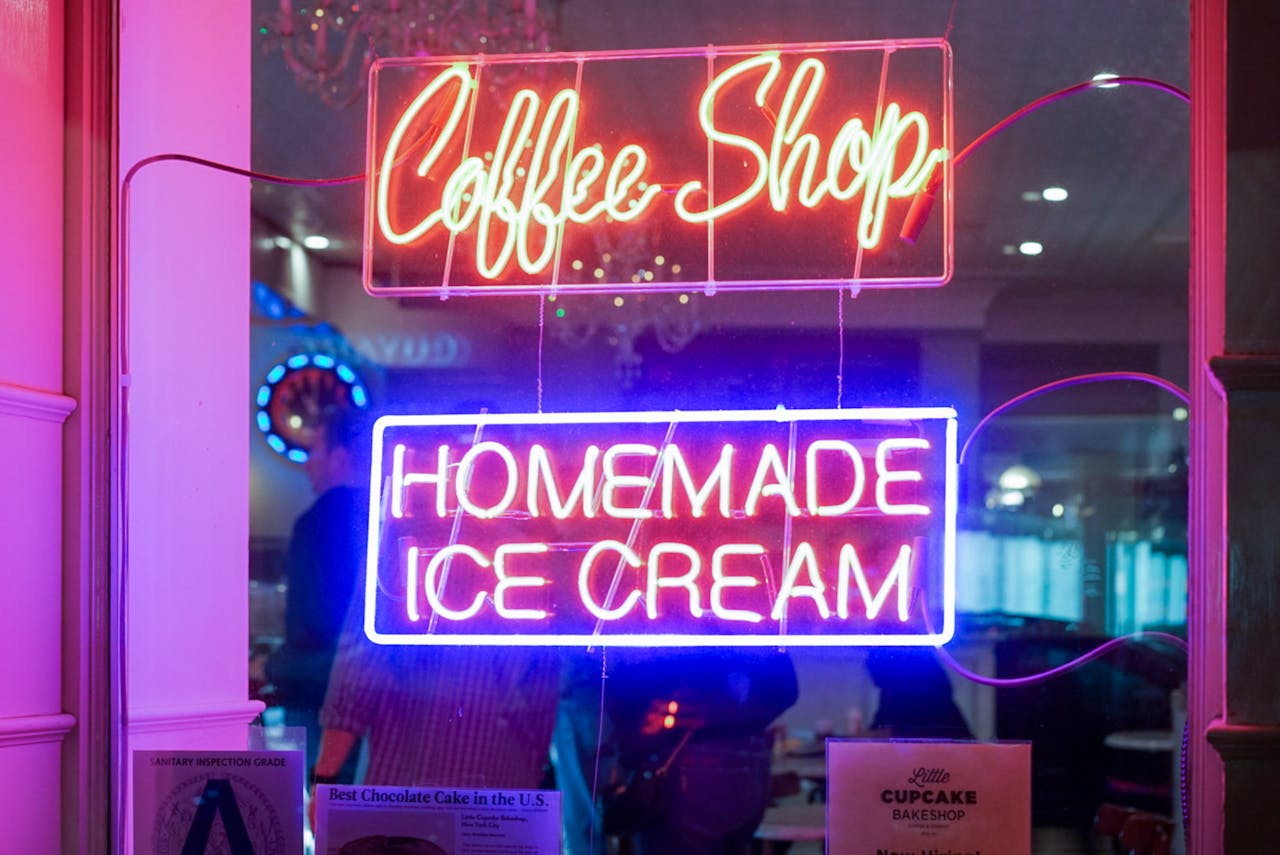 gallery-1 Vibrant neon signs for a coffee shop and homemade ice cream displayed indoors.